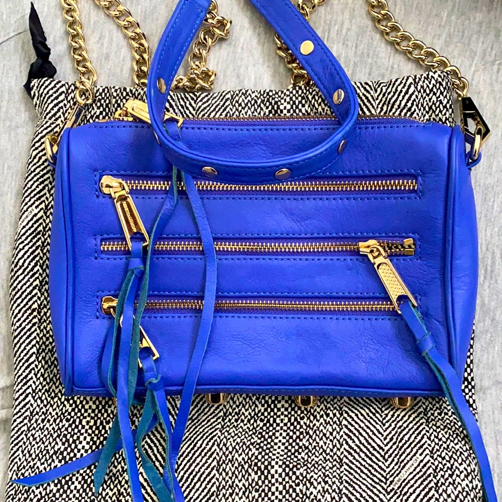 Pebbled leather camera bag with 4 zippers.